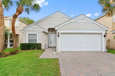 2 car garage with brick paver driveway