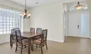 Light and bright dining room comfortably seats at least 6