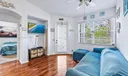 Living Room with access door to outdoor balcony. Vaulted ceilings, knockdown texture walls and wood-look laminate flooring.