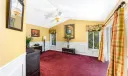 Primary Bedroom with white wainscoting and garden access