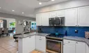 Quartzite counters and bold navy back splash