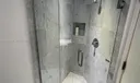 Shower in bathroom in front of convertible den