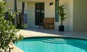 PRIMARY BEDROOM OPENS TO POOL