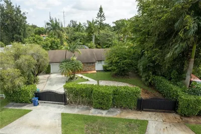 Gated front yard, circular driveway with lots of p