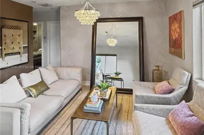 Bright, open-concept living room with tile floors