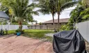Backyard with grass and pavers
