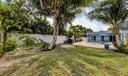 Fenced yard with grass and pavers