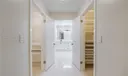 View from master bedroom past closets into master bathroom