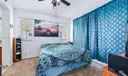 Primary Bedroom with ensuite bathroom and walk-in closet. Slider doors to access outdoor balcony.