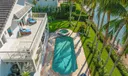 Expansive Waterfront Retreat with Terraces Overlooking Pool and Lush Greenery!