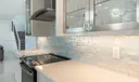 Mother of pearl subway tile backsplash, quartz counter top, GE Profile Hood
