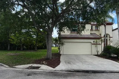 Front of house. 2 car garage and side yard