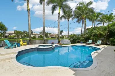 Gorgeous pool home on water with a backyard oasis