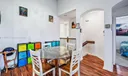 Entry to open Dining Area, Kitchen and Living Room with vaulted ceilings, knockdown texture walls and wood-look laminate flooring.