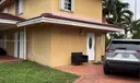 Side view of home and paved driveway leading to front of door.