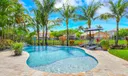 Spectacular backyard oasis with salt-water pool, equipped tiki-hut & waterfront views.