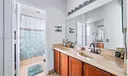 Primary Bathroom with tub/shower combo and walk-in closet. Ensuite to Primary Bedroom.