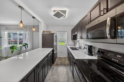 Large Galley Kitchen - Espresso cabinets and Quart