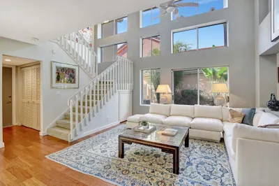 Soaring ceilings and this wall of windows create d