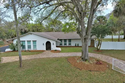 Ranch-style house with stucco siding and roof with