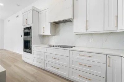 Stunning designer kitchen with Quartz range hood a