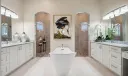 Primary Bathroom with double vanities, walk-through shower, tub.