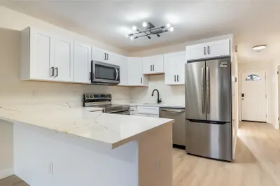 Modern kitchen, SS Appliances, Corian Counters. Be