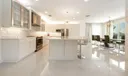 Open Floorpan | Over 250K in Upgrades | Kitchen & Dining Area w/ views to the Lake and the Pool area.