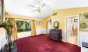 Primary Bedroom with white wainscoting and garden access.