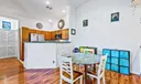 Dining Area, open Kitchen and Living Room with vaulted ceilings, knockdown texture walls and wood-look laminate flooring.
