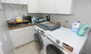 Inside laundry room with plenty of cabinets