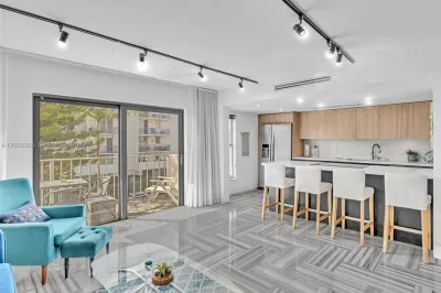 Stylish sunny living room open to kitchen