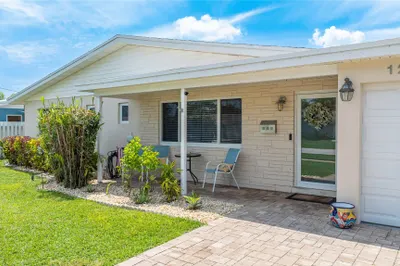 Front facade of home with paver driveway, 1 car ga
