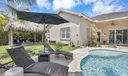 100K redone resort style backyard w pool and tiki hut outdoor longue area