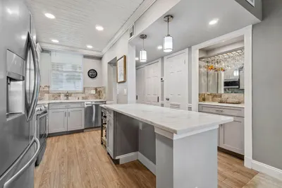 Updated and open kitchen boasts shaker style cabin