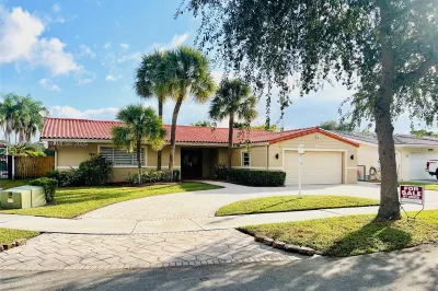 Front of house has circular driveway with brick pa
