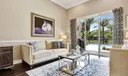 Wide hurricane protected windows let in a glow of natural light while enjoying a gorgeous pool and lake view