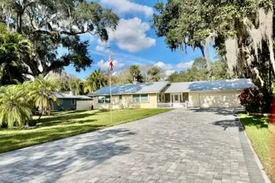 26? wide paver driveway. Parks 8 cars.