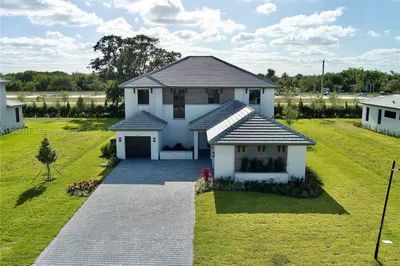 Front view including 2 single car garage