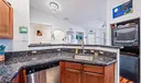 Open Kitchen with granite countertops, breakfast bar and stainless-steel appliances. Vaulted ceilings and tile flooring. Stackable Washer and Dryer-2022.