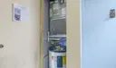 HVAC/Water Heater in separate space in common hallway next to condo unit.