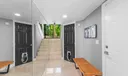 Entry foyer has custom mirrors to enlarge the space, garage interior entry to the right. Ahead is the entry to the main garden area