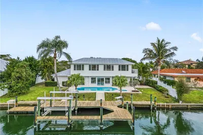 Back of Home showing water access, dock, lift, poo